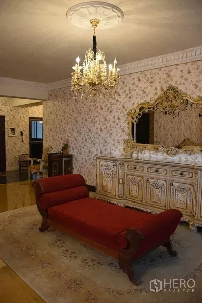 คอนโด ให้เช่าในWatthana, Bangkok - ห้องนั่งเล่นสไตล์วินเทจ โซฟาเดย์เบดสีแดง ตู้บาร์ลายทอง ใต้โคมไฟคริสตัล