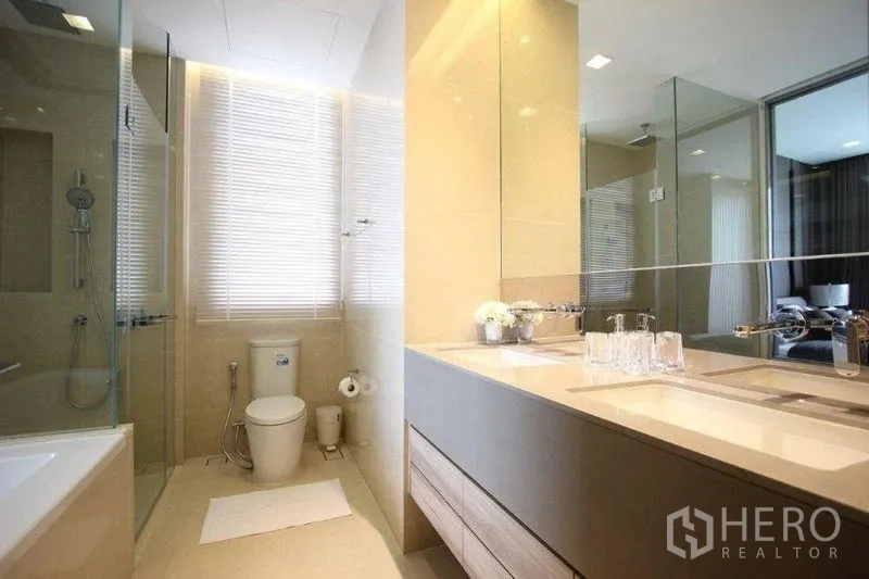 Condominium for rent in Watthana, Bangkok - Bright bathroom with double-sink vanity, shower and toilet by window blinds.
