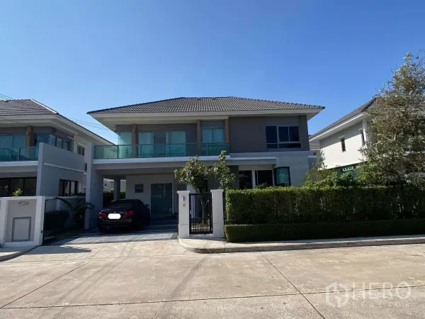 Detached House for rent in Bang Phli, Samut Prakan - Modern two-storey detached house with gated driveway and manicured hedges.