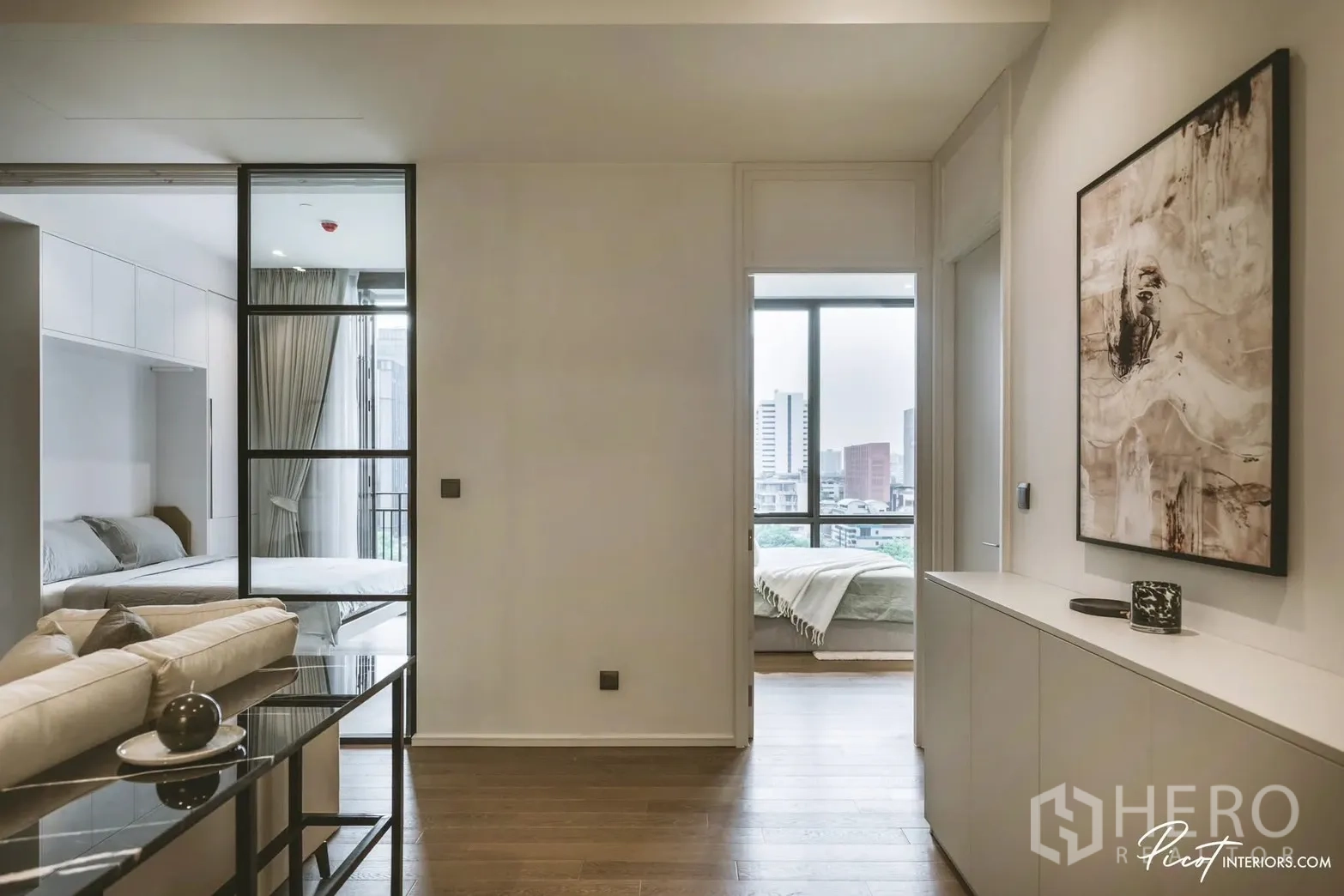 Condominium for rent in Pathum Wan, Bangkok - Hallway linking living area to bedrooms, each with large windows and city views.