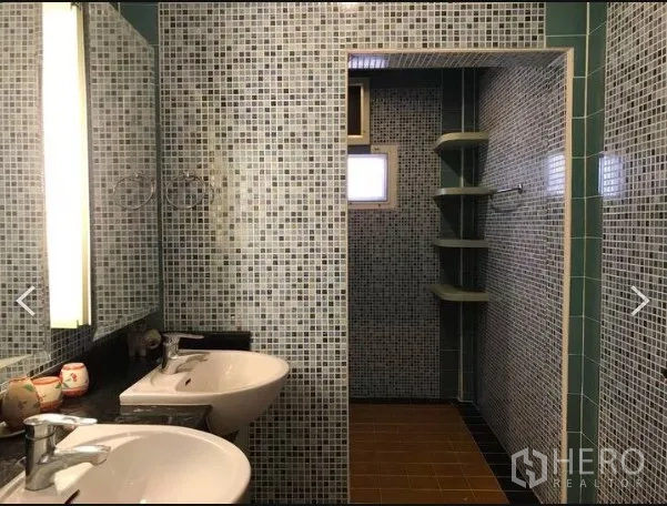 Detached House for sale in Saphan Sung, Bangkok - Mosaic-tiled bathroom with double sinks and walk-in shower with corner shelves.