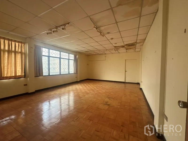 Office Space for rent - Empty office room with parquet floor and large windows
