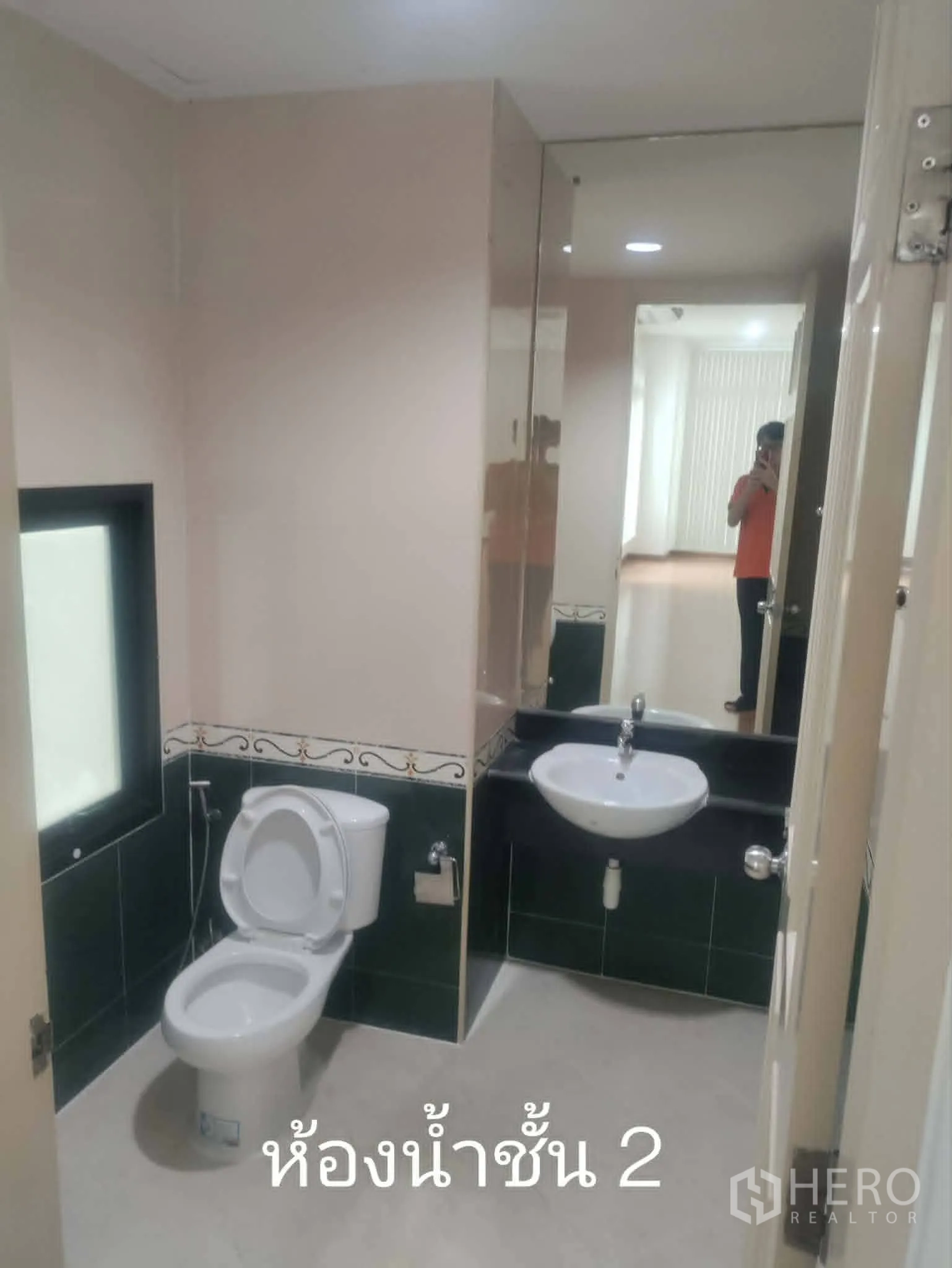 Home Office for rent in Lat Phrao, Bangkok - Bathroom with large mirror, toilet, and sink.
