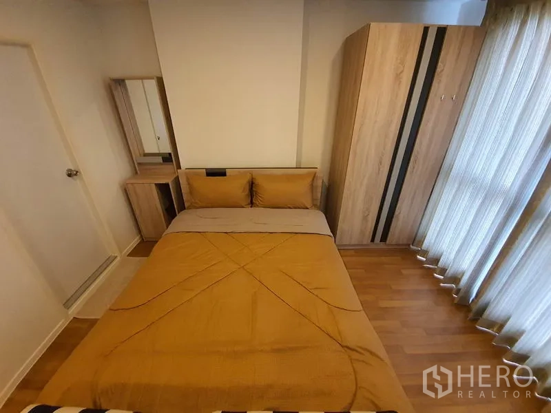 คอนโด ขายในChatuchak, Bangkok - มุมห้องนอนพร้อมเตียงคู่ ตู้เสื้อผ้า โต๊ะเครื่องแป้ง และผ้าม่านโปร่ง