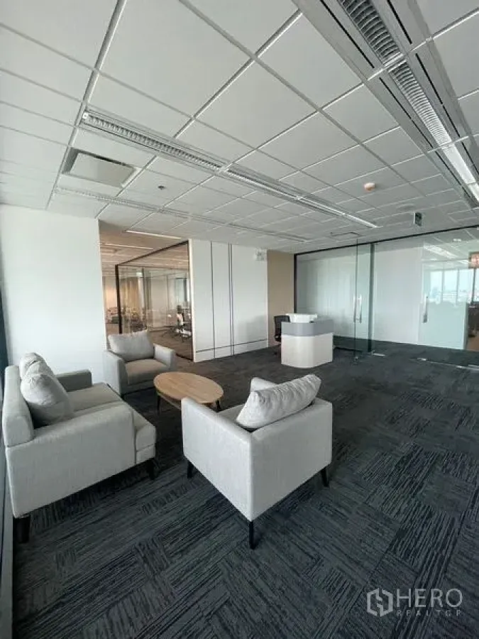 Office Space for rent in Dusit, Bangkok - Glass-partitioned private office with desk and chair, city view beyond.