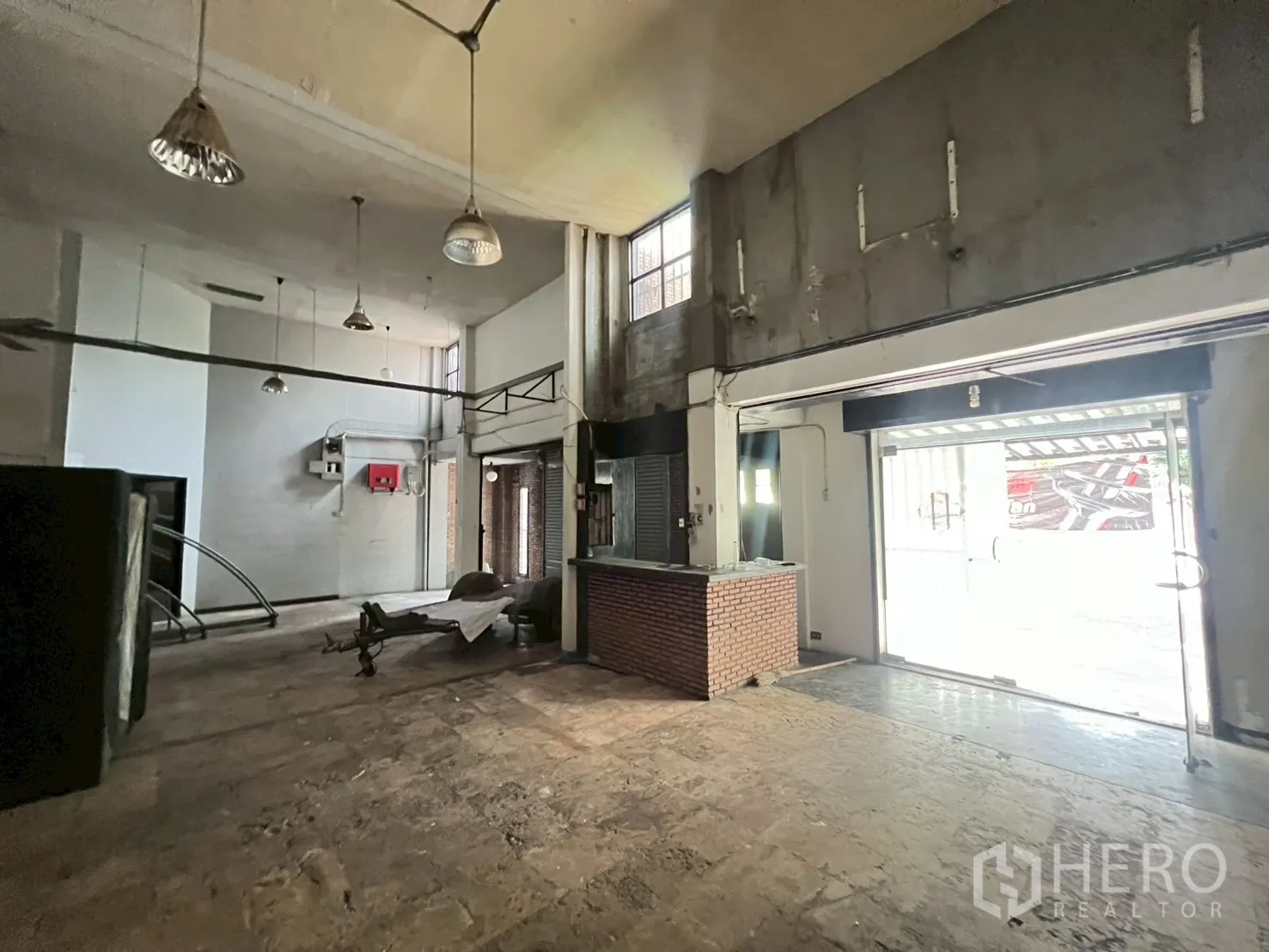 店屋 出租在Phra Khanong, Bangkok - 入口大厅，红砖接待台与通往前院的推拉玻璃门。