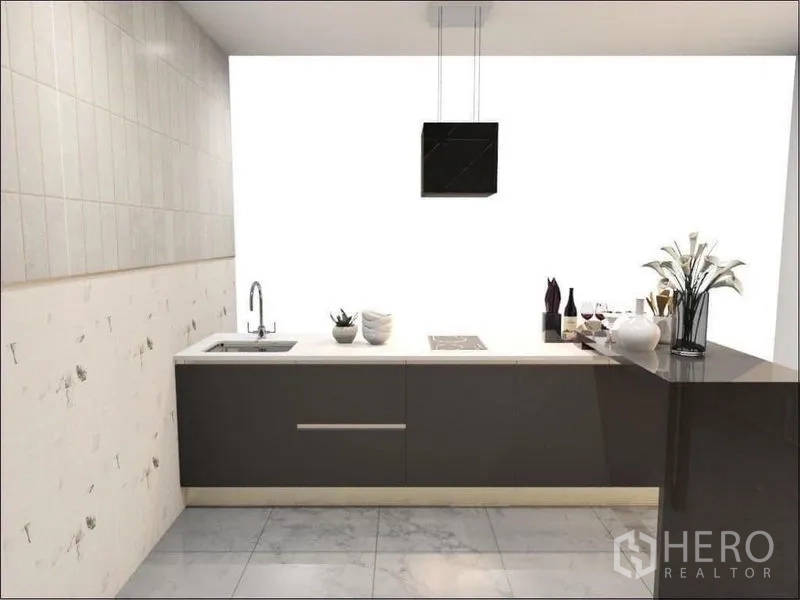 Detached House for sale in Suan Luang, Bangkok - Minimalist secondary kitchen with long counter, sink and cooktop against a clean white wall.