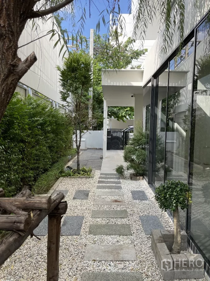 Home Office for rent in Don Mueang, Bangkok - Zen-style garden with pebble path, planters and floor-to-ceiling glass.