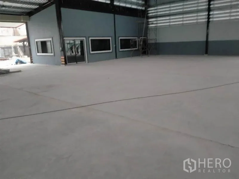 โรงงาน ให้เช่าหรือขายในPhanat Nikhom, Chon Buri - มุมโกดังที่มีหน้าต่างออฟฟิศ นั่งร้าน และพื้นคอนกรีตเรียบ