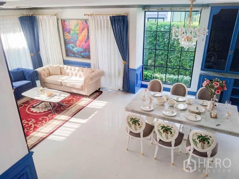 Detached House for rent or sale in Saphan Sung, Bangkok - View from staircase over bright living and dining space with chandeliers.
