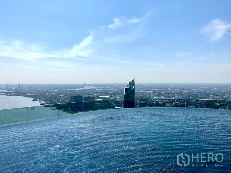 Condominium for rent or sale in Bangkok - Rooftop infinity-edge swimming pool overlooking the Chao Phraya River and Bangkok skyline.