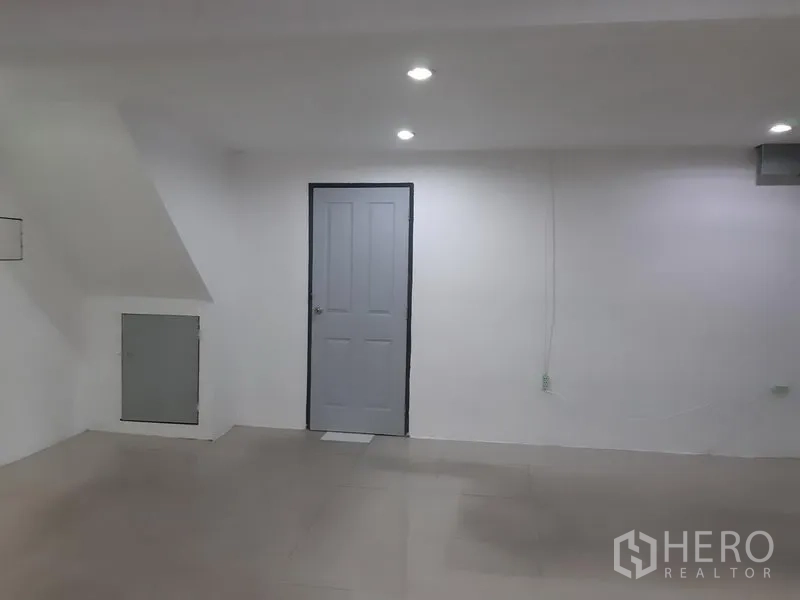 Office Space for rent in Khlong Toei, Bangkok - Bright white interior with tiled floor, recessed lights and a gray door.