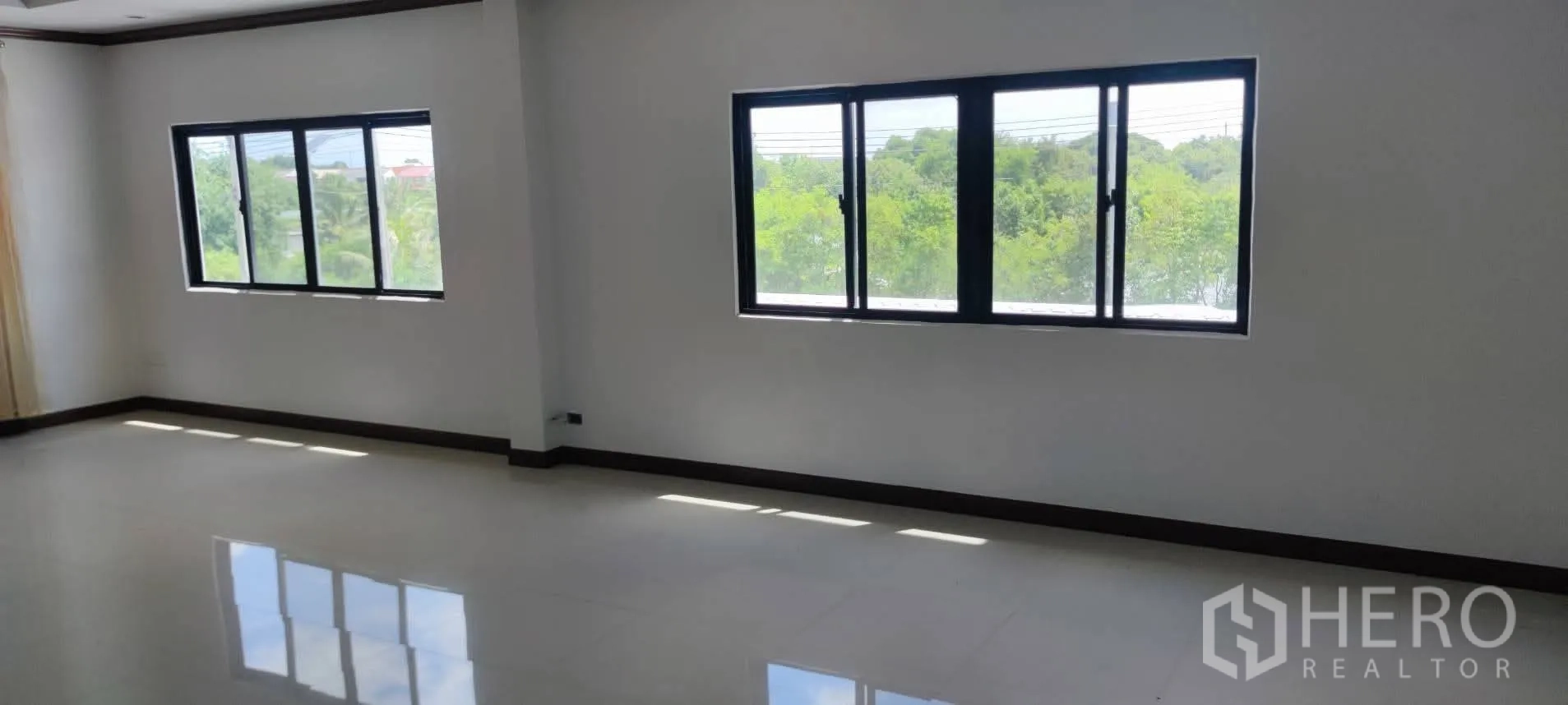 Warehouse for sale in Thung Khru, Bangkok - Bright upper-floor room with multiple windows and green views.
