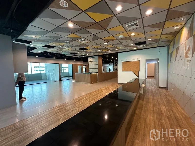 Office Space for rent in Ratchathewi, Bangkok - Reception zone with patterned ceiling, long counter and wood flooring.