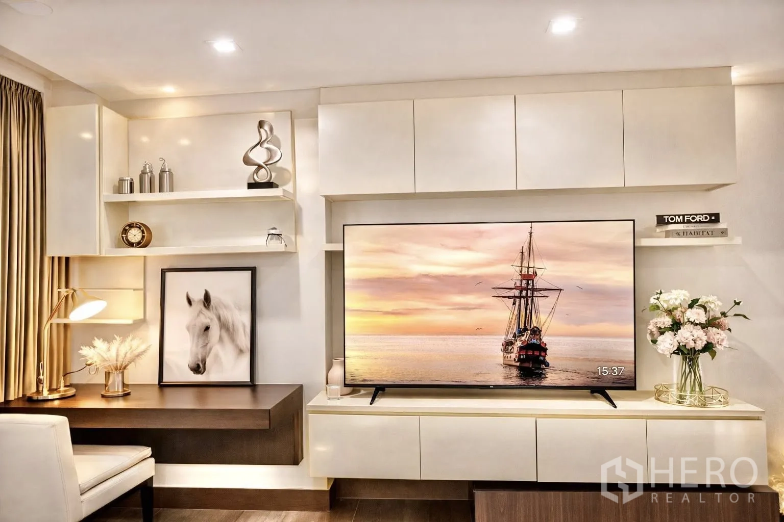 Condominium for rent or sale in Watthana, Bangkok - Built-in media wall with shelves, desk, and an extra-large flat-screen TV.