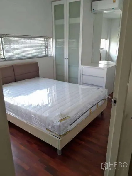 独立式住宅 出租在Bang Kruai, Nonthaburi - 明亮卧室，双人床、玻璃门衣柜与木地板，Bang Kruai 独栋别墅。