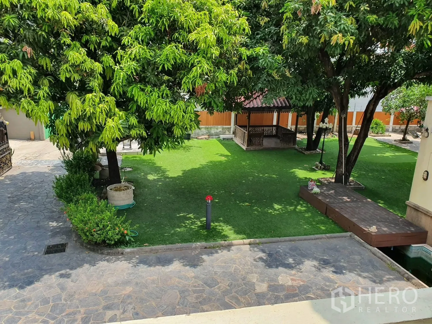 Detached House for rent in Sathon, Bangkok - Landscaped yard with lawn, mature trees, and a wooden gazebo pavilion.