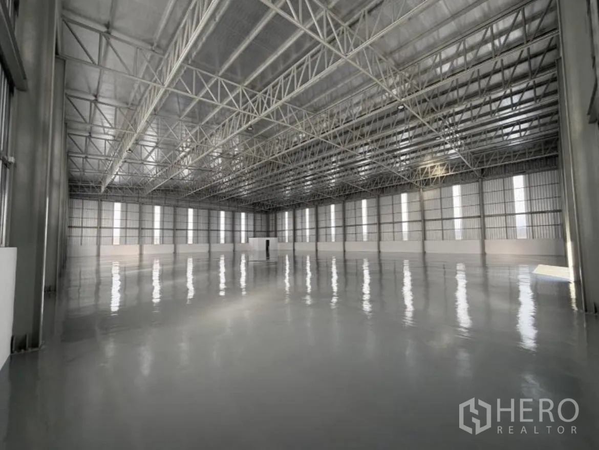 Warehouse for rent in Bang Khun Thian, Bangkok - Central perspective of the clear-span space with vertical light panels.