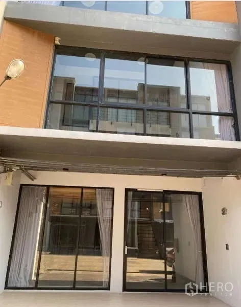 Home Office for rent or sale - Front exterior of the home office with wide glass frontage and upper balcony windows.