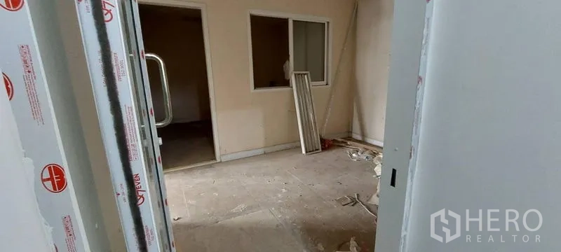 Shophouse for sale - Entrance to interior room under construction with window cutout.