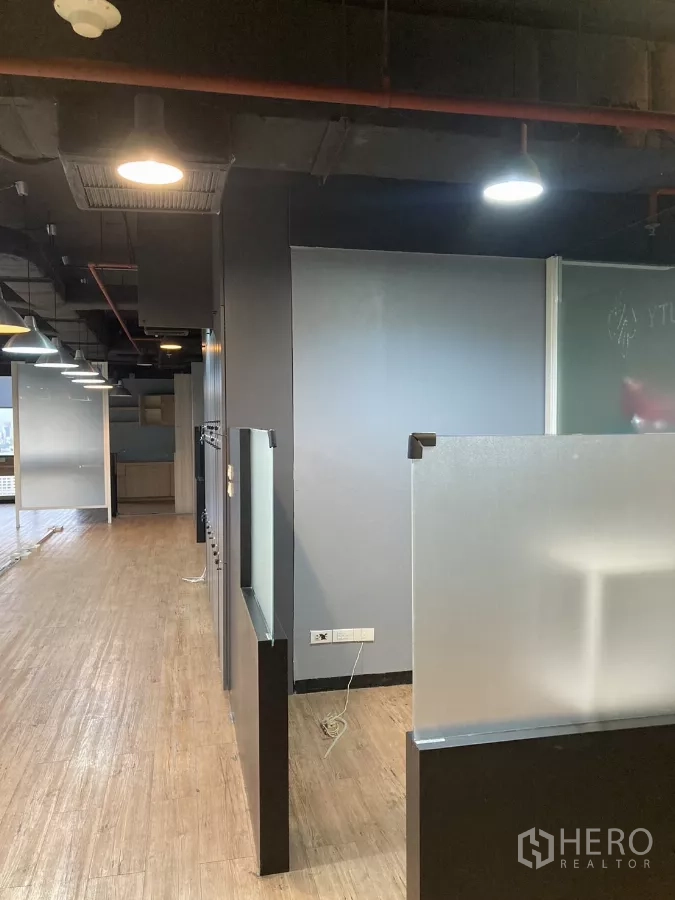 Office Space for rent in Watthana, Bangkok - Office corridor with frosted dividers, exposed ceiling and wooden floors in Watthana, Bangkok.