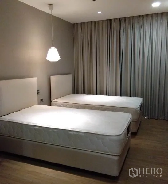 อพาร์ทเมนท์ ให้เช่าในKhlong Toei, Bangkok - ห้องนอนที่สอง เตียงเดี่ยวสองเตียง โคมไฟแขวน และผ้าม่านทึบแสง