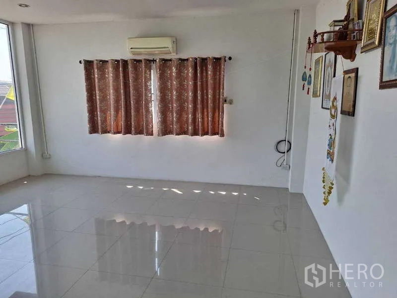 Warehouse for sale in Pathum Thani - Air-conditioned office room with tiled floor and curtained window.