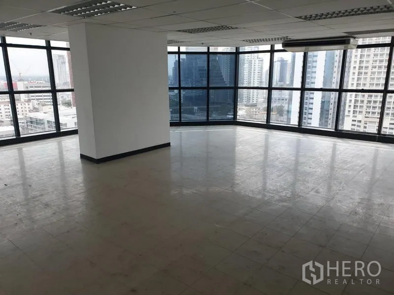 Office Space for rent in Watthana, Bangkok - Open-plan corner office with floor-to-ceiling windows overlooking the Bangkok skyline.