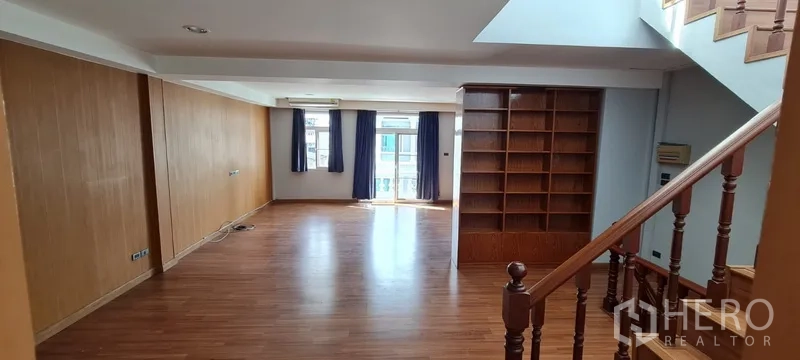 Home Office for rent - Upper‑floor multipurpose room with wood floors, bookcase and balcony doors