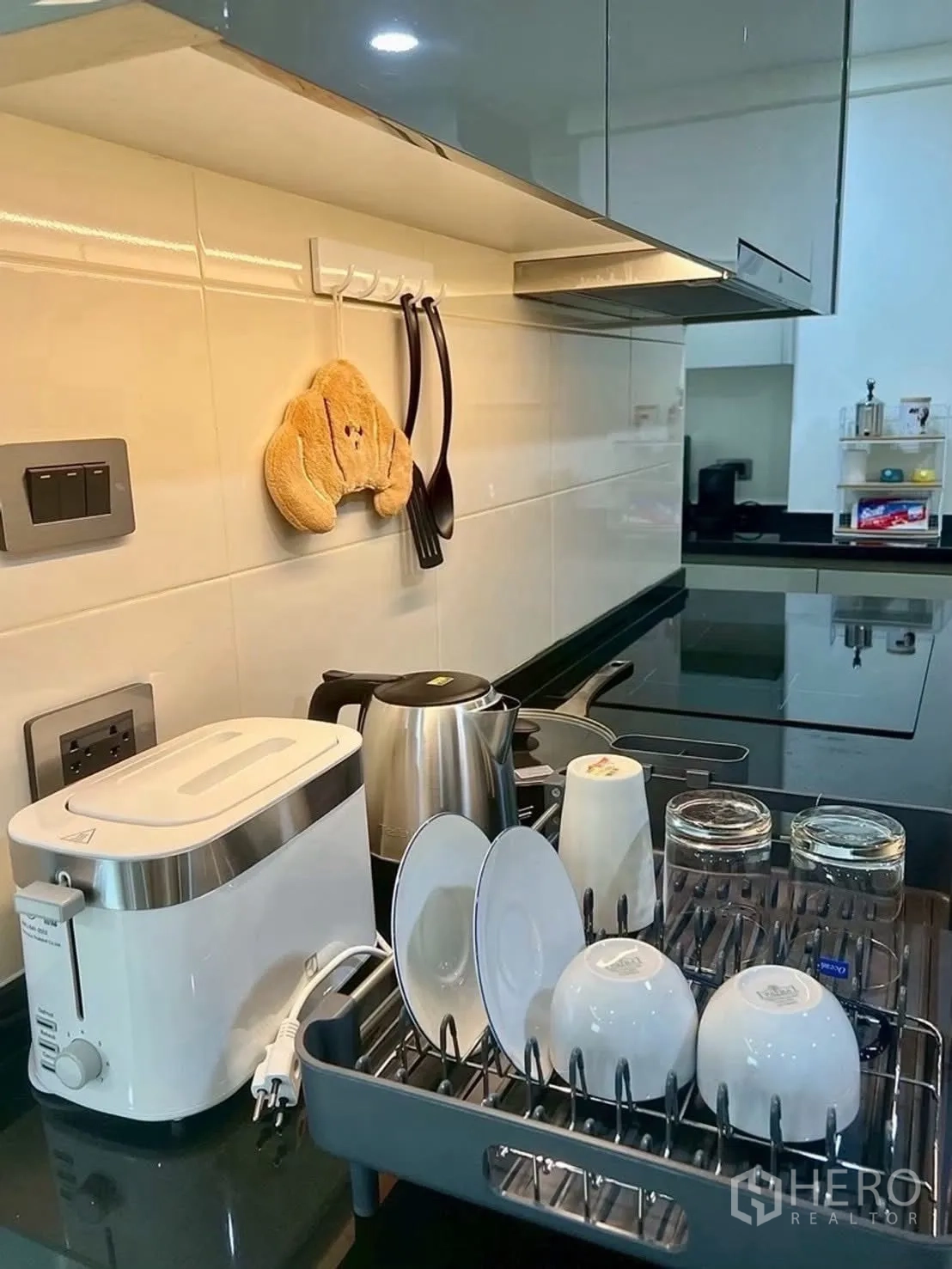 Condominium for rent in Huai Khwang, Bangkok - Kitchen countertop with toaster, kettle, and dish rack.