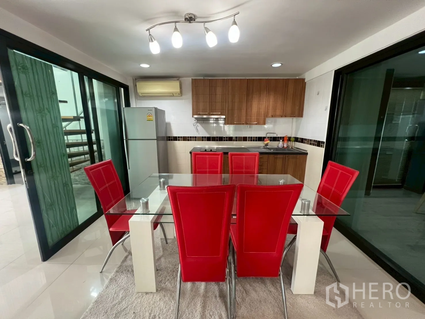 Detached House for rent or sale in Wang Thonglang, Bangkok - Dining zone beside the kitchen with refrigerator and ceiling lights.