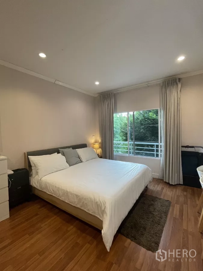 บ้าน ขายในMin Buri, Bangkok - ห้องนอนใหญ่ เตียงคิงส์ ไม้ปาร์เกต์ และหน้าต่างมองวิวต้นไม้ที่ระเบียง