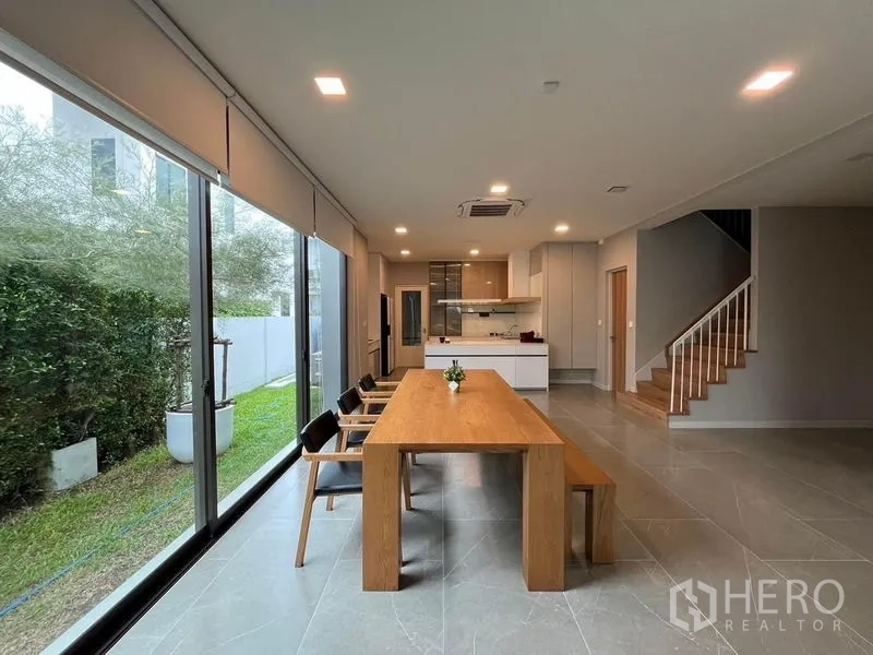 บ้าน ให้เช่าหรือขาย - พื้นที่ทานอาหารและครัวแบบเปิด ผนังกระจกเต็มบานมองสวนส่วนตัวและบันได
