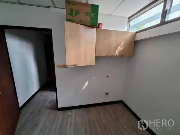 Office Space for rent in Watthana, Bangkok - Compact utility room with wood wall cabinets, clerestory window and vinyl flooring.