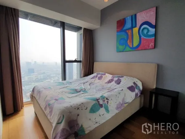 公寓 出租在Sathon, Bangkok - 卧室含床与彩色画作，落地窗城市景观。