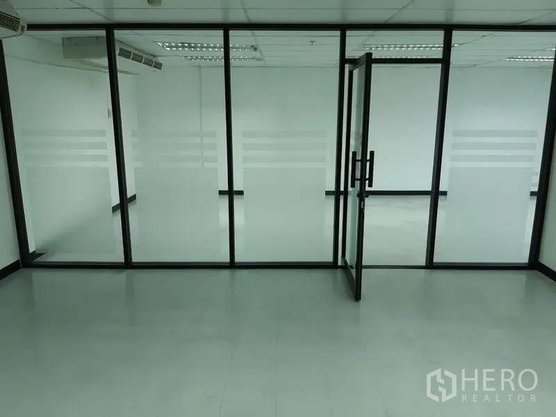 Office Space for rent in Watthana, Bangkok - Meeting room enclosed by frosted glass panels with black frames.