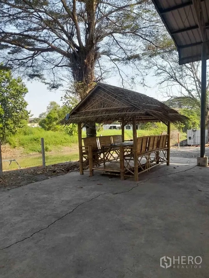 Factory for rent in Mueang Chachoengsao, Chachoengsao - Bamboo pavilion seating under a tree within the factory grounds.