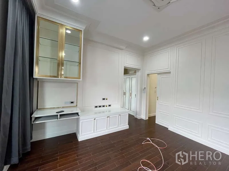 Detached House for sale in Thawi Watthana, Bangkok - Built-in white cabinetry with gold-trim glass display and study desk