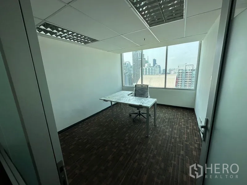 Office Space for rent in Watthana, Bangkok - Private corner office with large window, L-shaped desk and Bangkok skyline view.