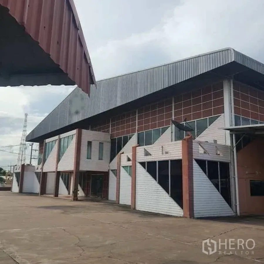 Warehouse for sale in Rayong - Modern warehouse exterior with angular facade and wide concrete yard in Pluak Daeng.