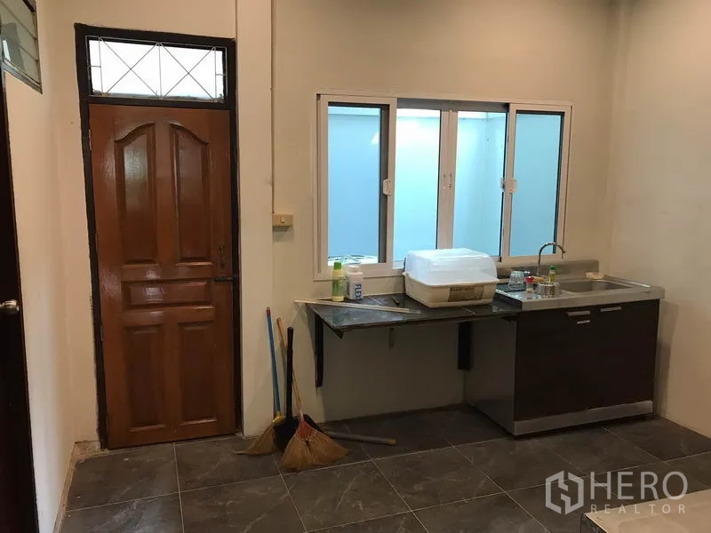 ทาวน์เฮาส์ ให้เช่าหรือขายในPhra Khanong, Bangkok - ครัวส่วนรองพร้อมอ่างล้างจาน หน้าต่างบานเลื่อน ประตูไม้ และพื้นกระเบื้อง