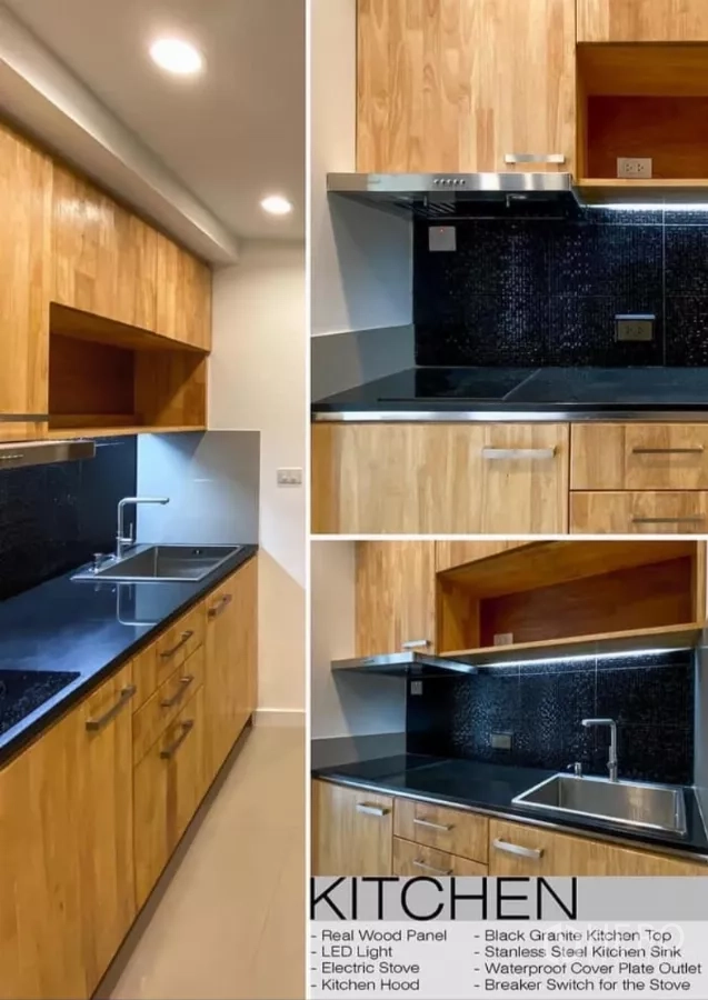 Detached House for rent in Huai Khwang, Bangkok - L-shaped kitchen with real-wood cabinets, black granite countertop, sink and cooktop with hood.