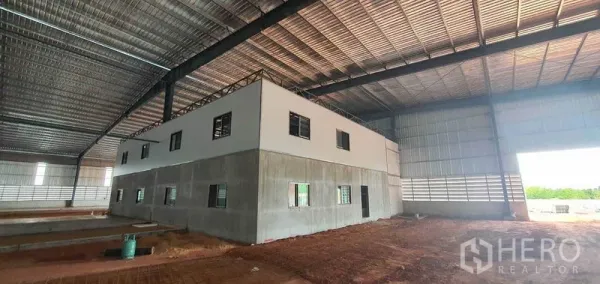 Factory for rent in Mueang Samut Sakhon, Samut Sakhon - Two-storey internal office block inside a large warehouse with metal roofing and ventilation panels.