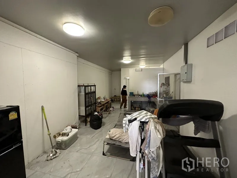 Warehouse for sale in Bang Khen, Bangkok - Utility or staff room with tiled floor and basic fittings inside the warehouse.