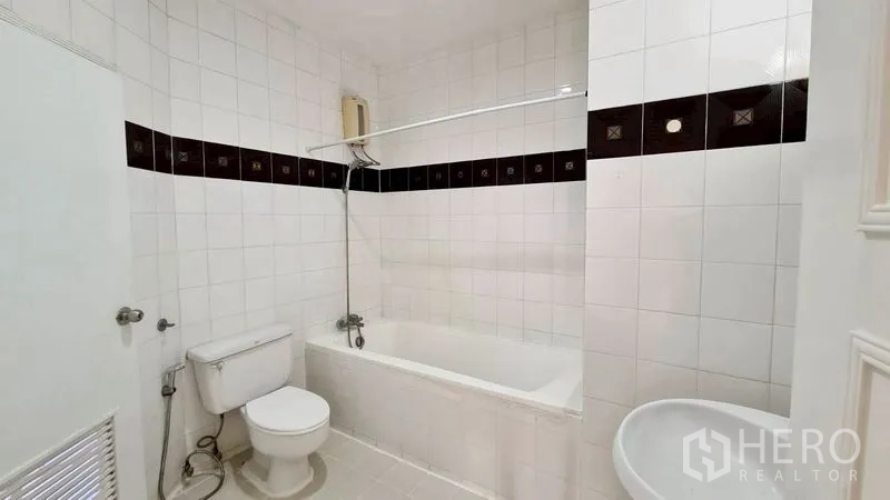 Condominium for rent in Watthana, Bangkok - Tiled bathroom with bathtub, shower, and toilet.