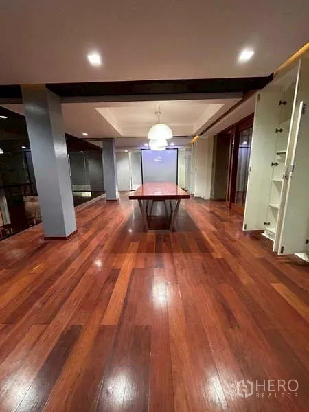 Home Office for rent or sale in Bang Phli, Samut Prakan - Large meeting or open-plan area with polished hardwood floor, pendant lights and central table.