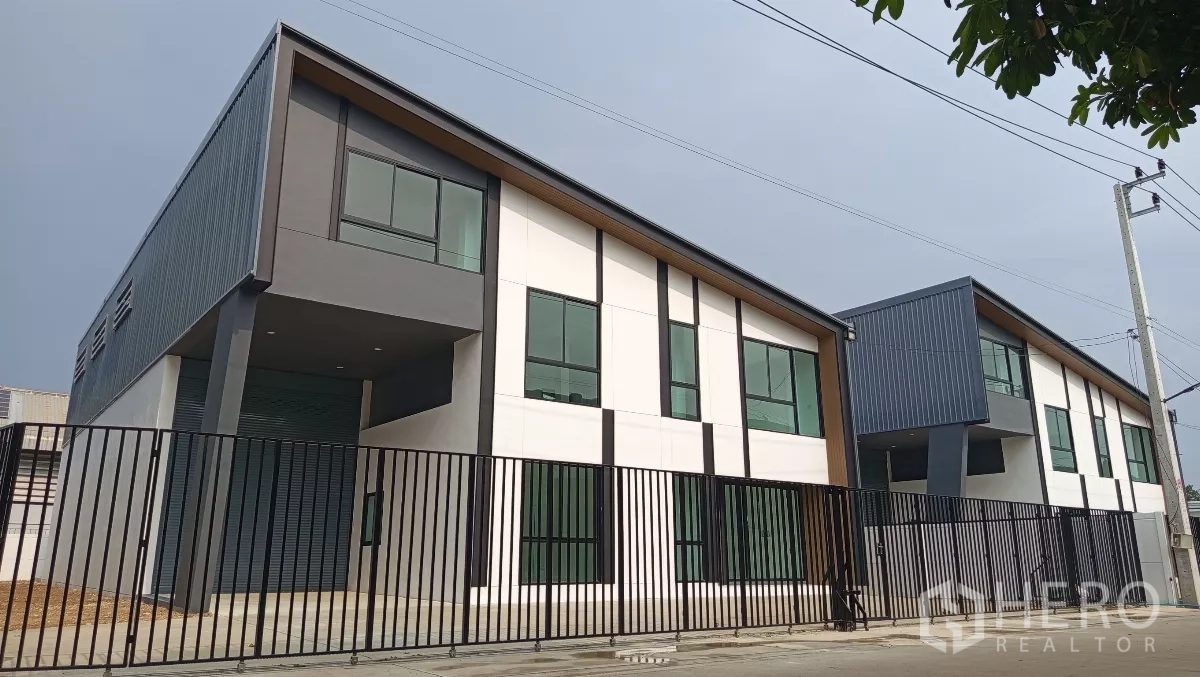 货栈 出租或出售在Lam Luk Ka, Pathum Thani - 全新现代风仓库，斜屋顶与大窗，前方黑色金属围栏，位于Lam Luk Ka。