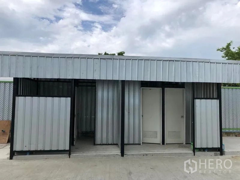 Warehouse for rent in Pathum Thani - Close-up of separate restroom entrances in the service building next to the warehouse.