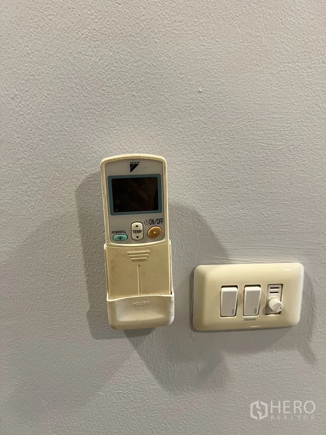 Office Space for rent in Bang Rak, Bangkok - Wall-mounted air-conditioning remote and light switches inside the office.