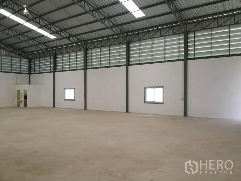 货栈 出租在Lam Luk Ka, Pathum Thani - 开放式库内空间，设有通风板、小窗与内置卫生间区域。